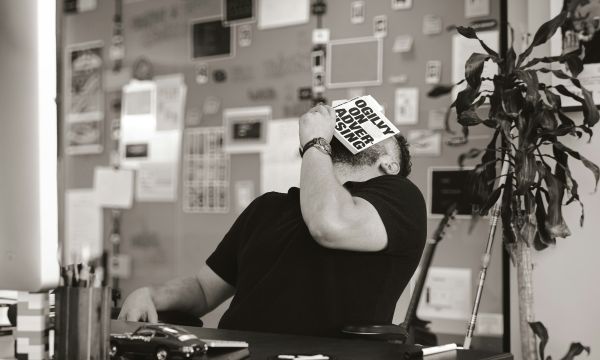 man-holding-book-in-face
